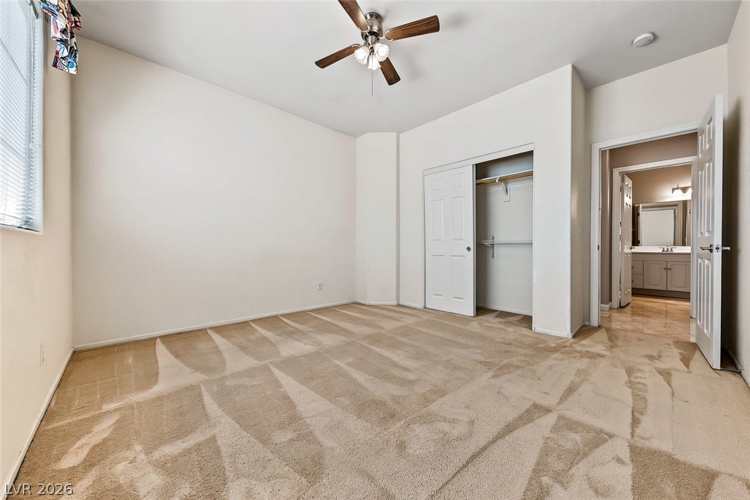2906 Pumpkin Harvest Avenue, North Las Vegas, NV 89031 Soft carpeting pairs with a built-in closet in this versatile bedroom space.