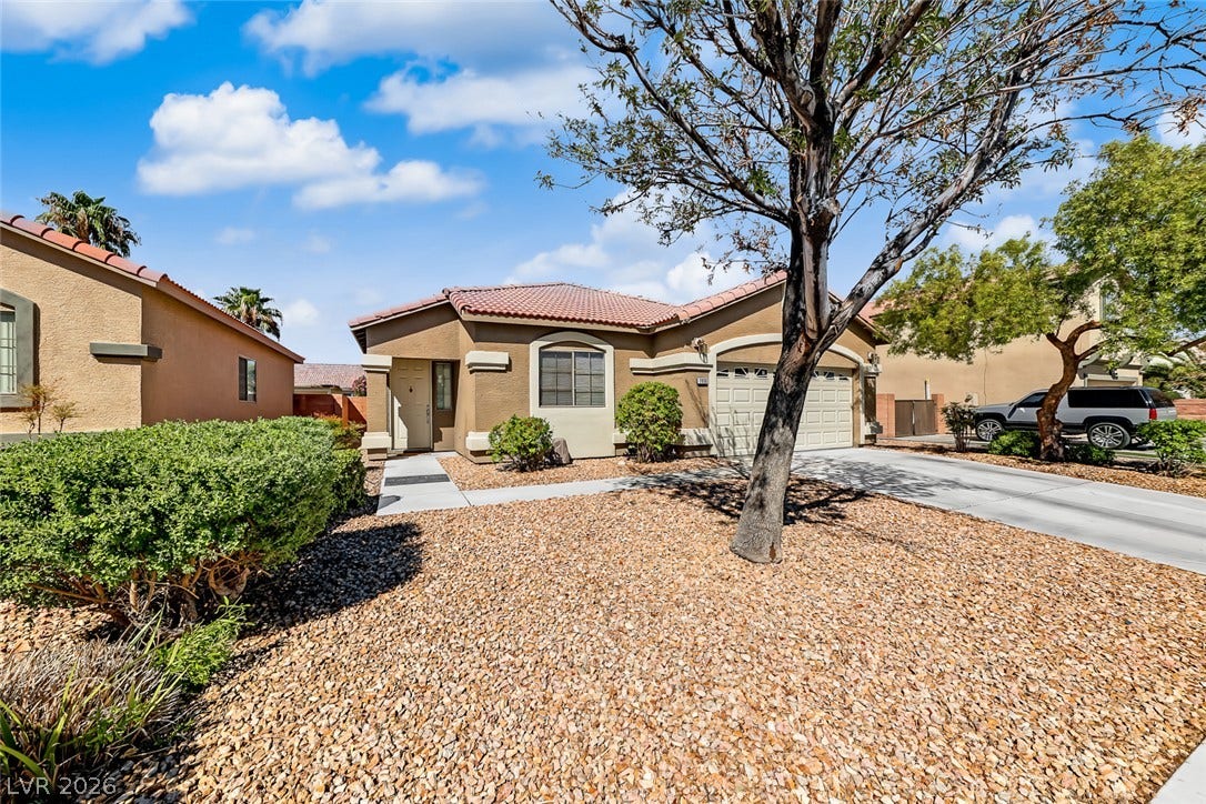 2906 Pumpkin Harvest Avenue, North Las Vegas, NV 89031 Classic tile roof and desert landscaping define this charming single-story home.