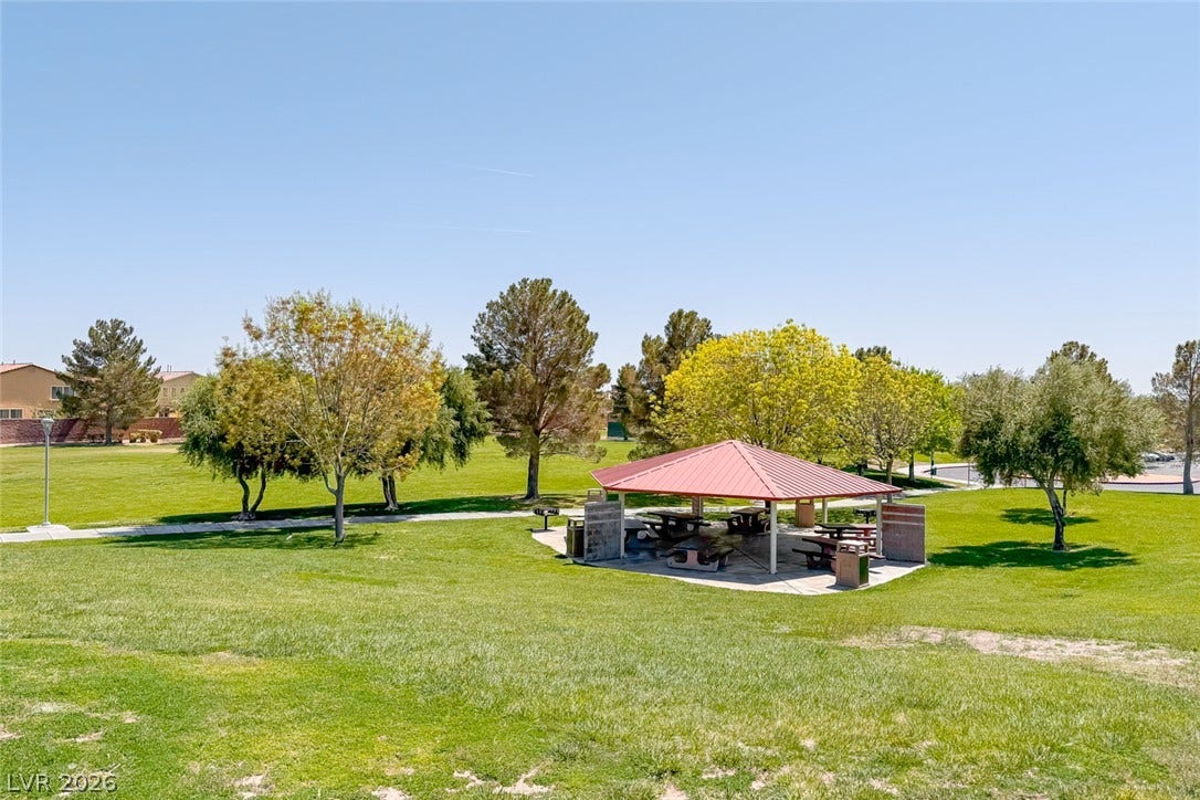 2906 Pumpkin Harvest Avenue, North Las Vegas, NV 89031 Mature trees and a shaded pavilion overlook the expansive neighborhood park green space.