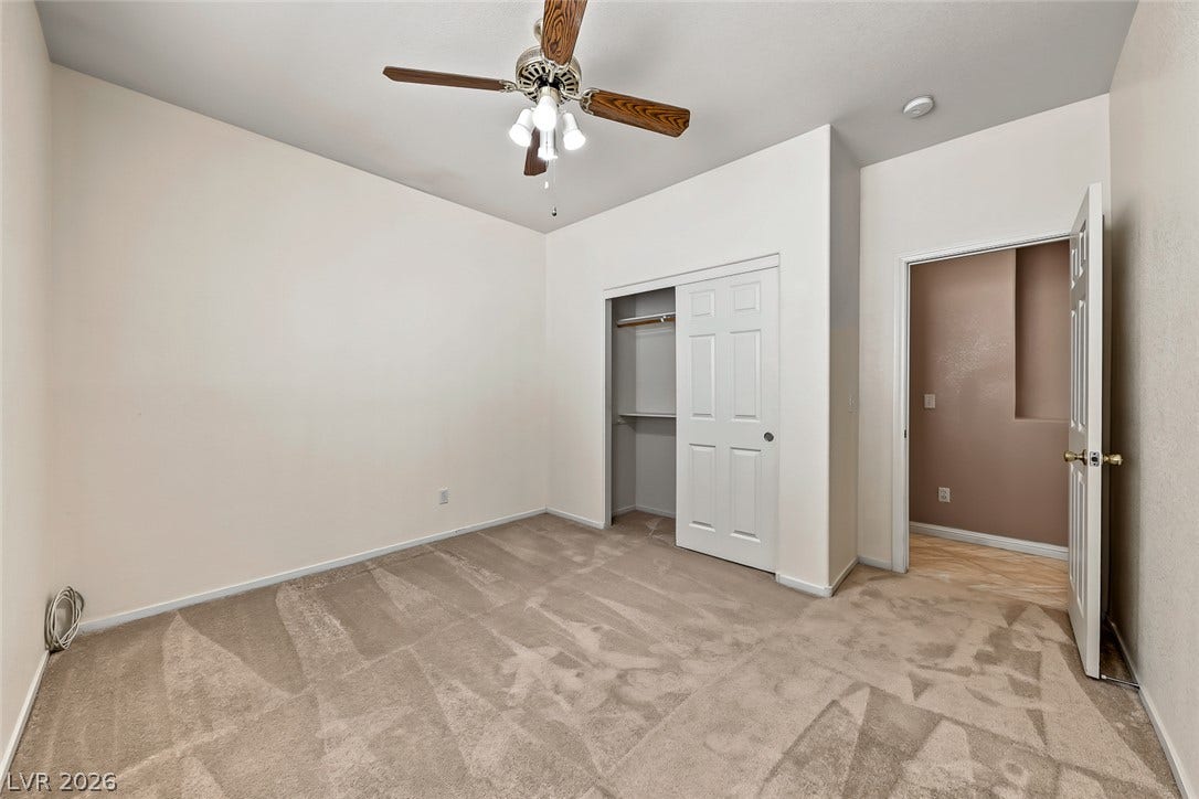 2906 Pumpkin Harvest Avenue, North Las Vegas, NV 89031 Plush carpeting anchors this quiet bedroom complete with a built-in closet storage system.