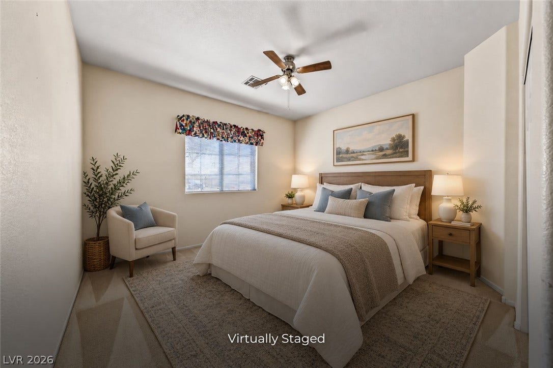 2906 Pumpkin Harvest Avenue, North Las Vegas, NV 89031 Plush carpeted floors and a large window define this inviting bedroom space.