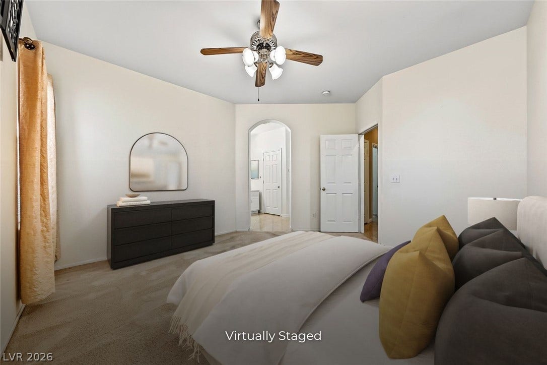2906 Pumpkin Harvest Avenue, North Las Vegas, NV 89031 An arched doorway leads to the adjoining bath from this carpeted bedroom.