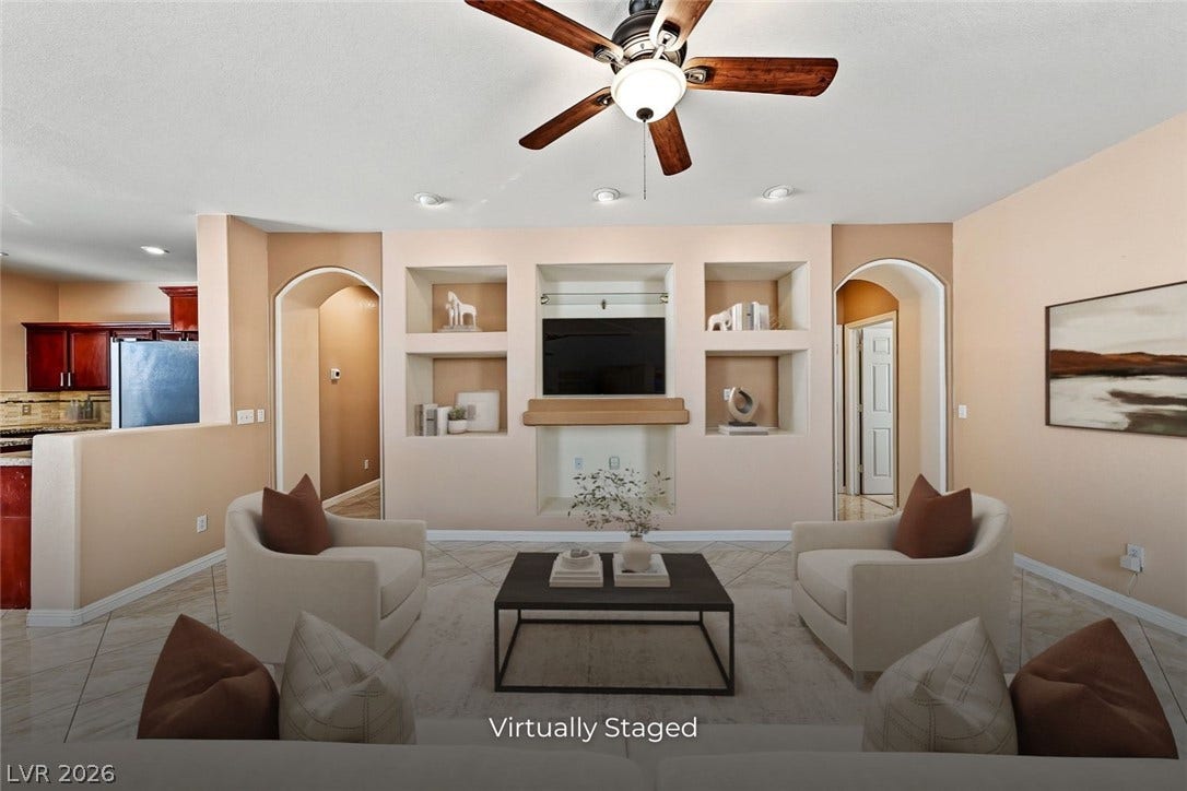 2906 Pumpkin Harvest Avenue, North Las Vegas, NV 89031 Arched doorways and custom built-in shelving define this open living area.