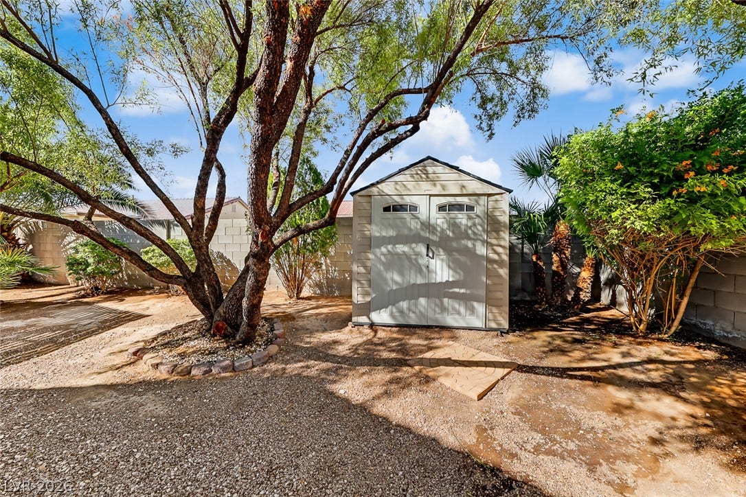 2906 Pumpkin Harvest Avenue, North Las Vegas, NV 89031 Mature trees shade a versatile storage shed within the privacy of a walled backyard.