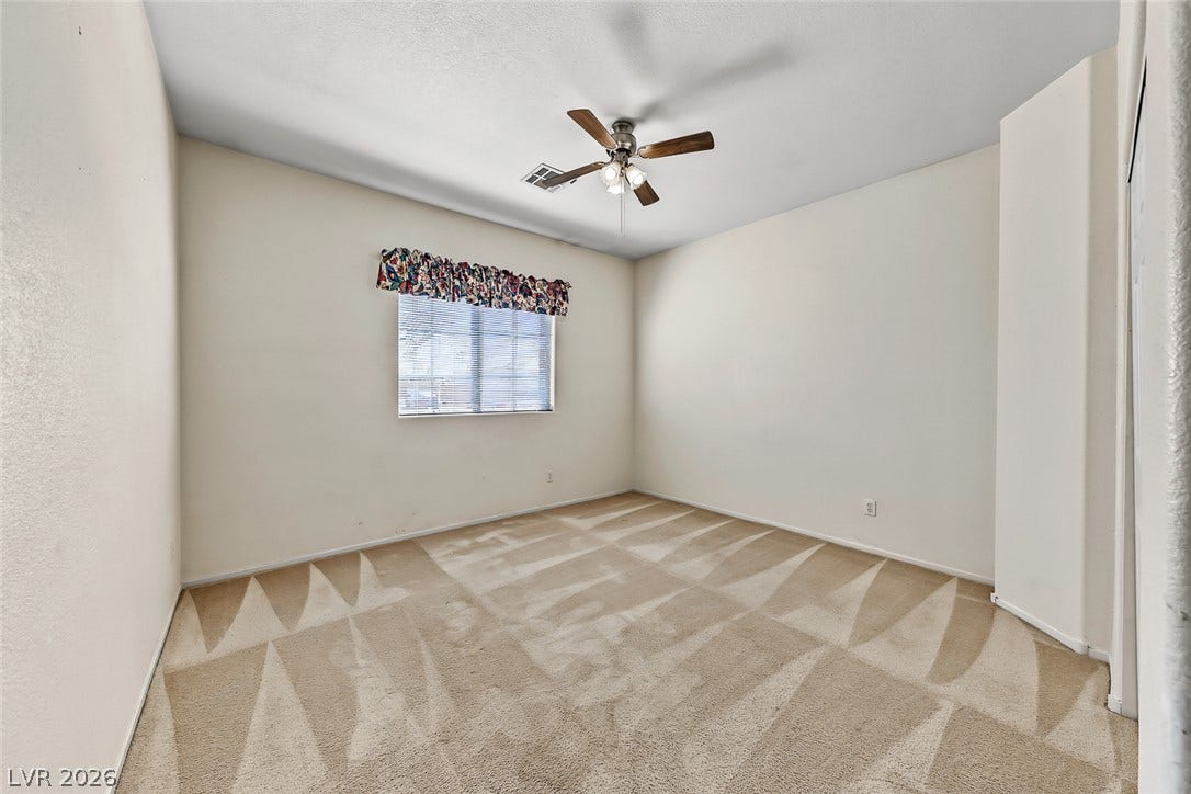 2906 Pumpkin Harvest Avenue, North Las Vegas, NV 89031 Soft carpeting pairs with a multi-pane window to create a quiet, comfortable bedroom.