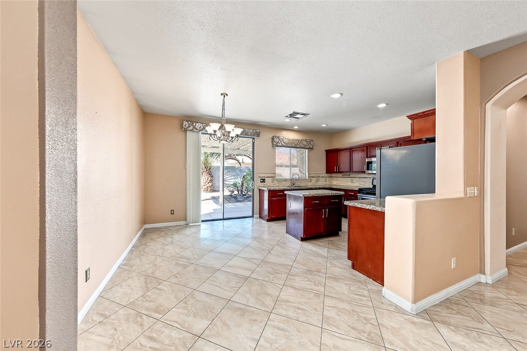2906 Pumpkin Harvest Avenue, North Las Vegas, NV 89031 Tiled flooring and wood cabinetry define this open kitchen and dining area.