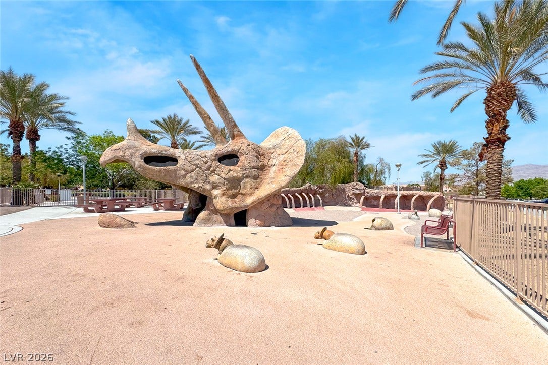 2906 Pumpkin Harvest Avenue, North Las Vegas, NV 89031 An imaginative community playground features unique climbing structures under clear desert skies.
