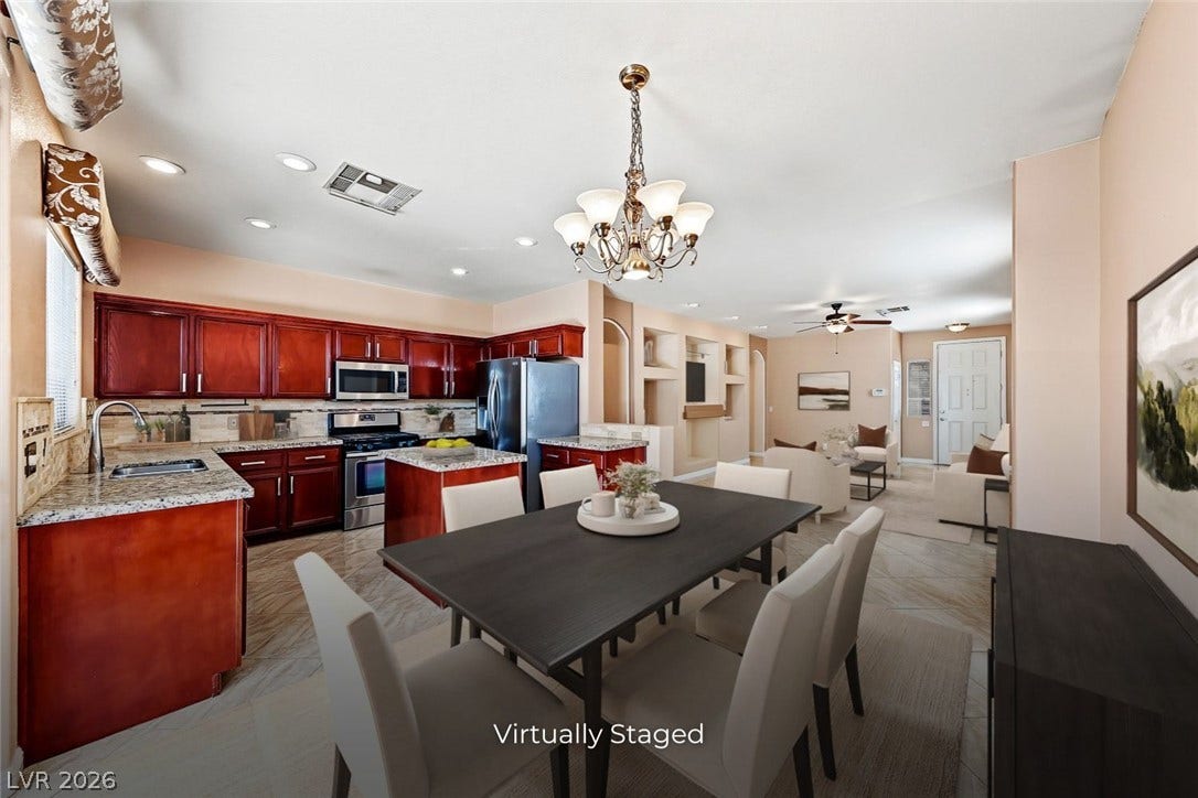 2906 Pumpkin Harvest Avenue, North Las Vegas, NV 89031 Granite countertops and warm wood cabinetry complement the open-concept kitchen and dining area.