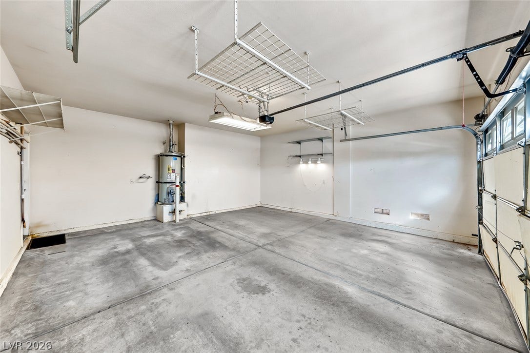 2906 Pumpkin Harvest Avenue, North Las Vegas, NV 89031 An accommodating concrete floor and overhead storage define this functional garage space.