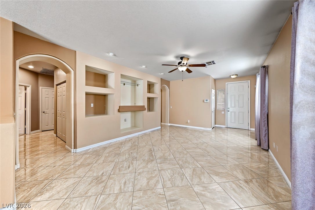 2906 Pumpkin Harvest Avenue, North Las Vegas, NV 89031 Gleaming tile floors and built-in wall niches define this welcoming open entryway.
