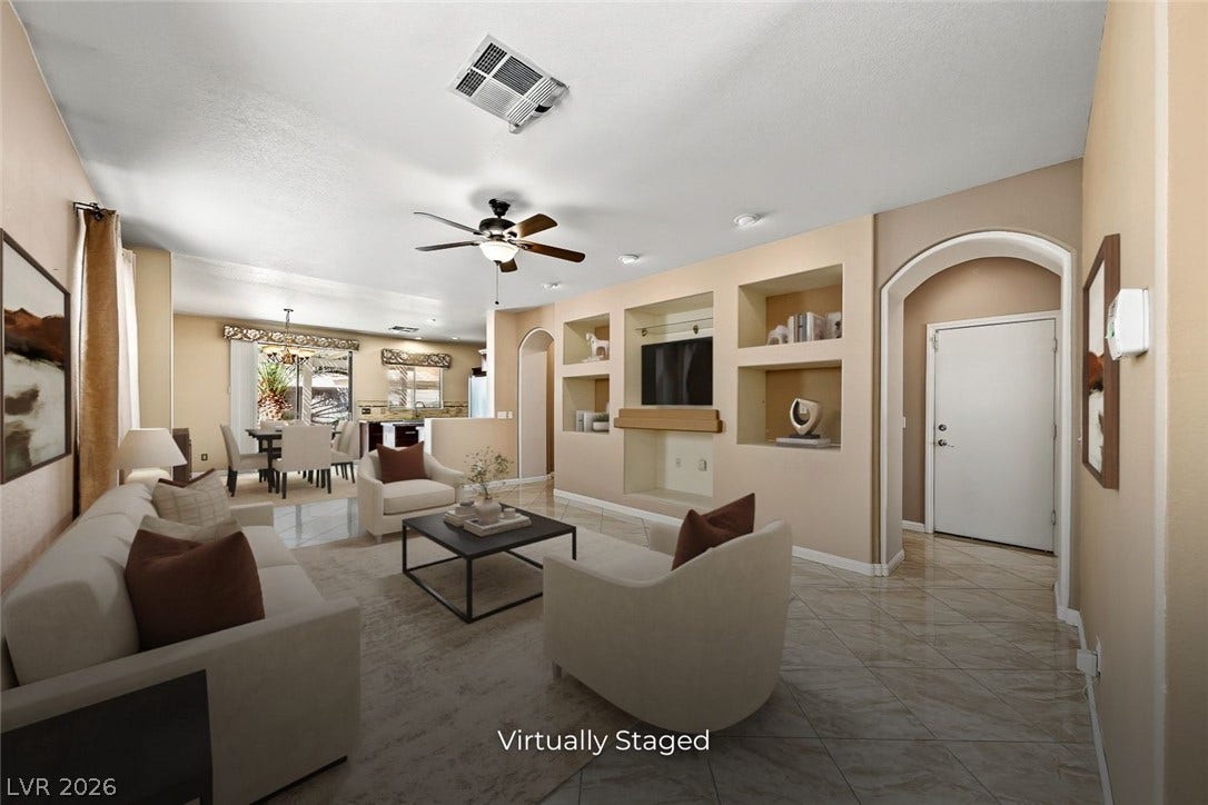 2906 Pumpkin Harvest Avenue, North Las Vegas, NV 89031 Polished tile flooring flows seamlessly through the open layout under a classic arched doorway.