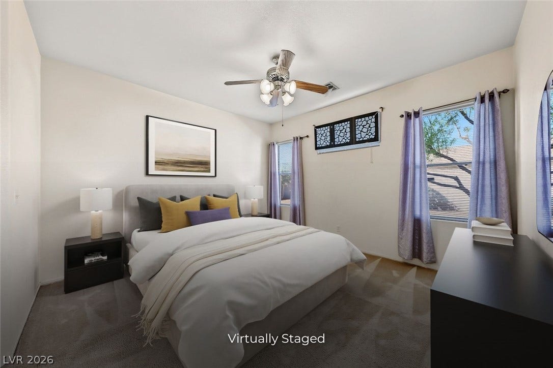 2906 Pumpkin Harvest Avenue, North Las Vegas, NV 89031 Generous windows fill this comfortable carpeted bedroom with natural light.