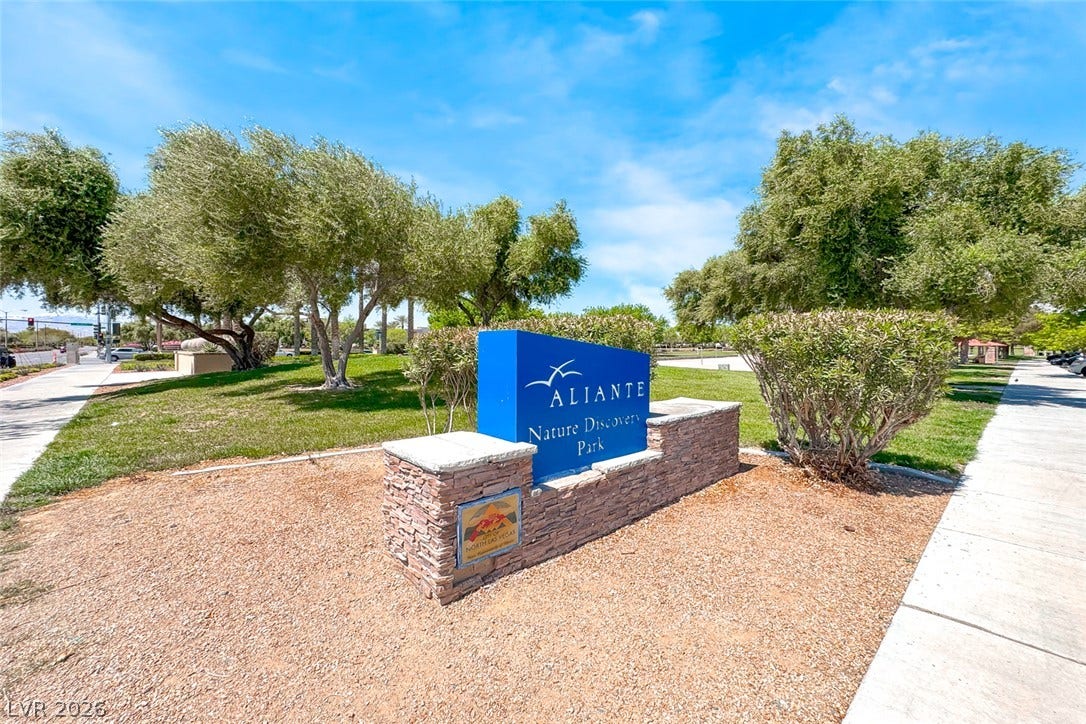 2906 Pumpkin Harvest Avenue, North Las Vegas, NV 89031 Lush green lawns and mature trees frame the entrance to the nearby community park.