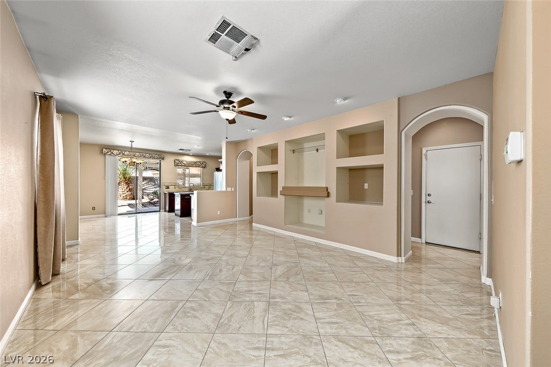 2906 Pumpkin Harvest Avenue, North Las Vegas, NV 89031 Gleaming tile floors and built-in wall niches define this open-concept main living space.