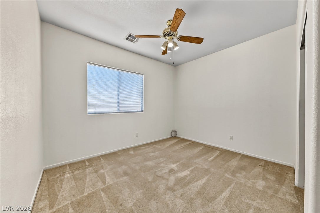 2906 Pumpkin Harvest Avenue, North Las Vegas, NV 89031 Plush carpeting and natural light define this versatile secondary room.