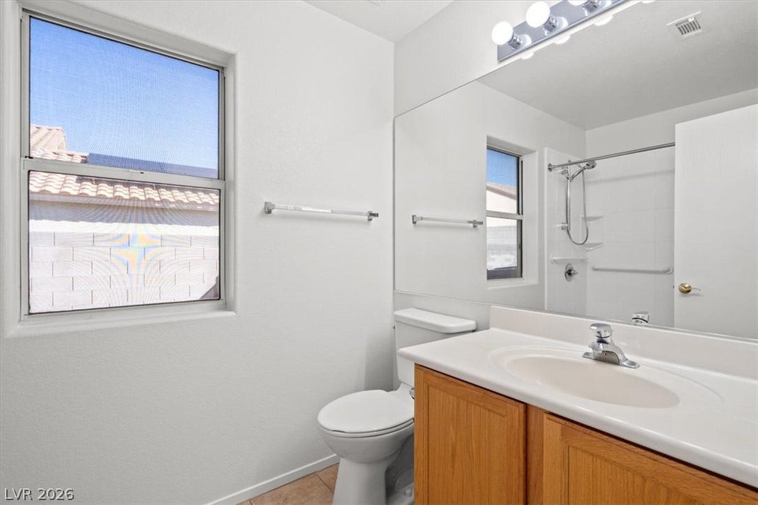 3535 Barrel Bronco Court, North Las Vegas, NV 89032 Natural light from a large window illuminates this functional bathroom space.