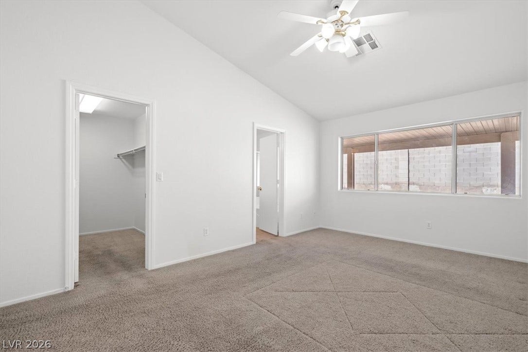 3535 Barrel Bronco Court, North Las Vegas, NV 89032 Plush carpeting and vaulted ceilings enhance this serene main bedroom with an attached walk-in closet.