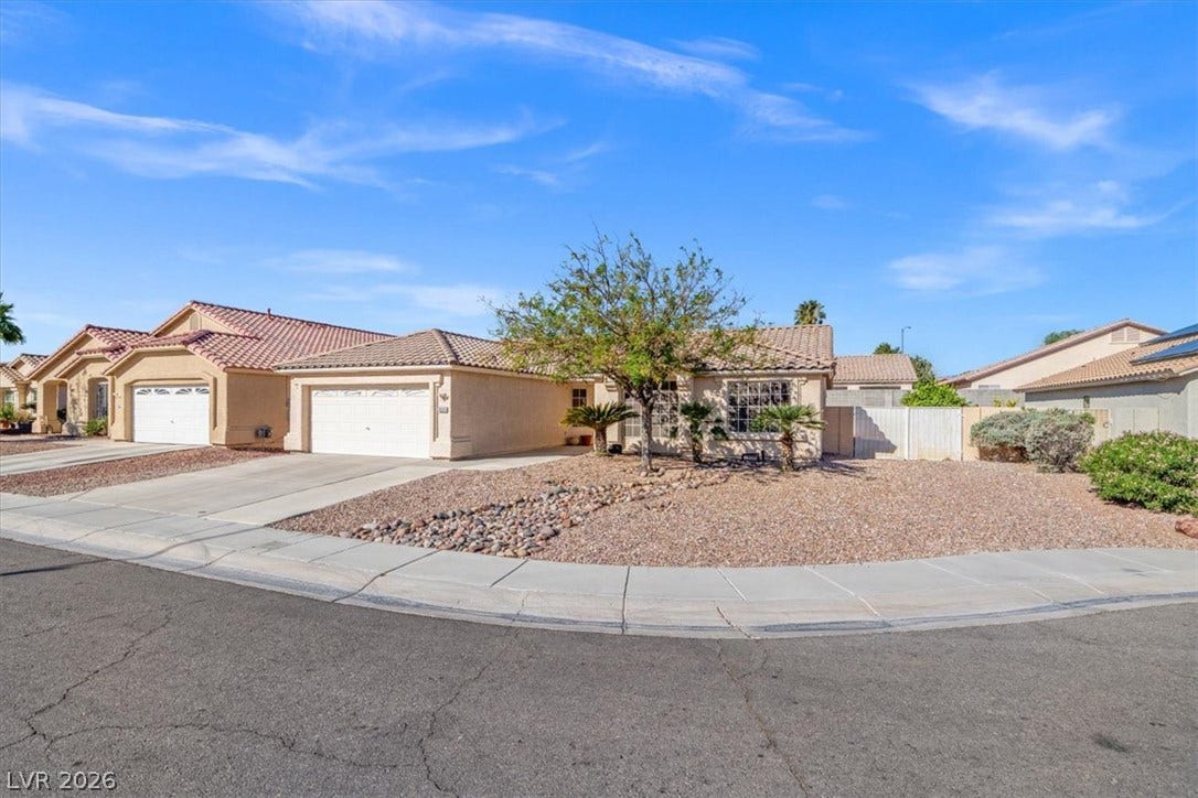 3535 Barrel Bronco Court, North Las Vegas, NV 89032 A classic stucco exterior sits on a low-maintenance corner lot with tile roofing.