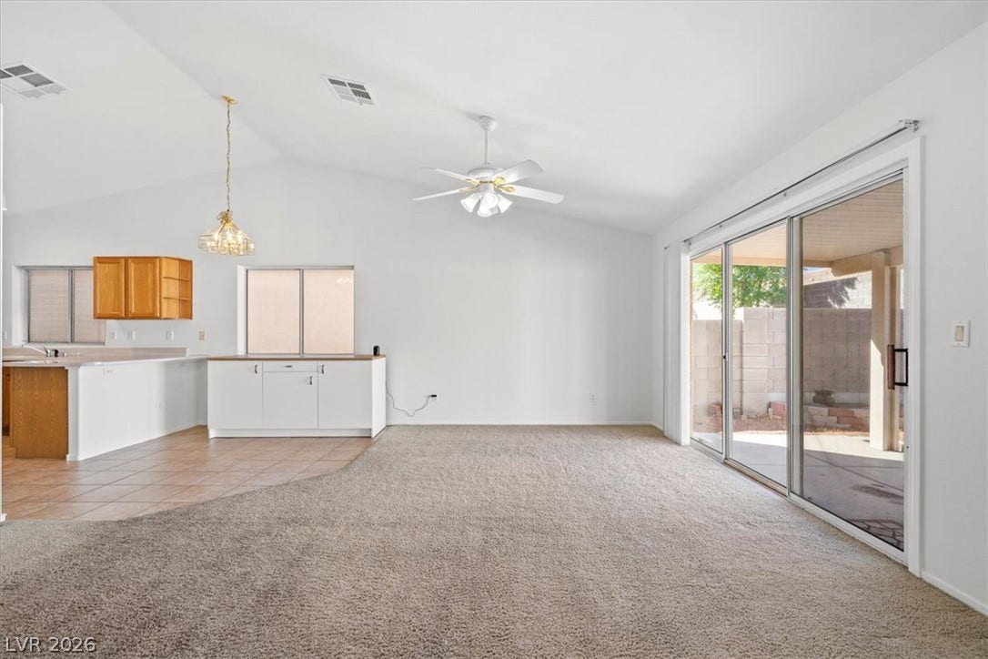 3535 Barrel Bronco Court, North Las Vegas, NV 89032 An open floorplan flows seamlessly from carpeted living spaces to tiled dining areas under vaulted ceilings.