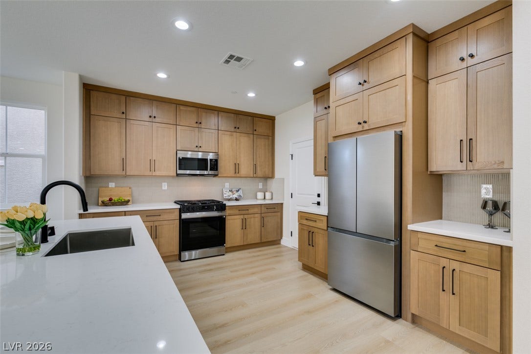 197 Sicily Hills Court, Henderson, NV 89012 Modern cabinetry and stone countertops frame this culinary space centered around a spacious island.