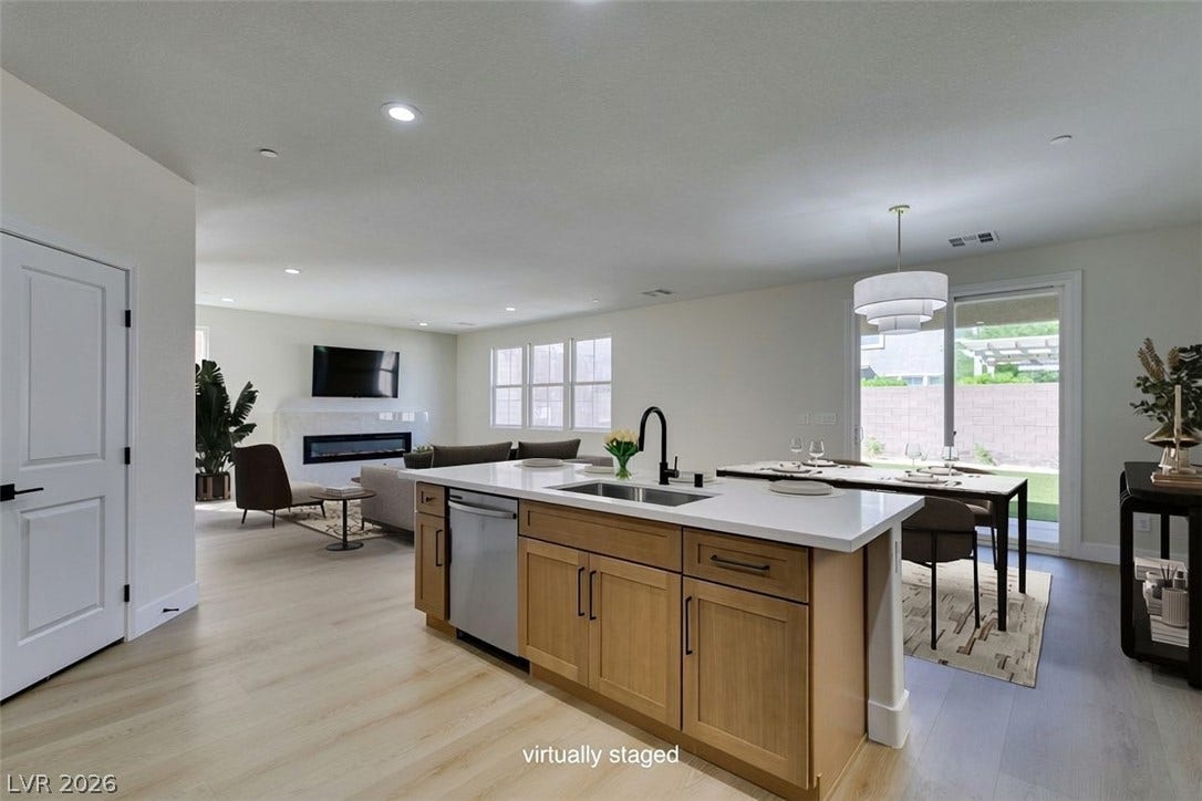 197 Sicily Hills Court, Henderson, NV 89012 An open floorplan seamlessly connects the kitchen and dining area to the living room.