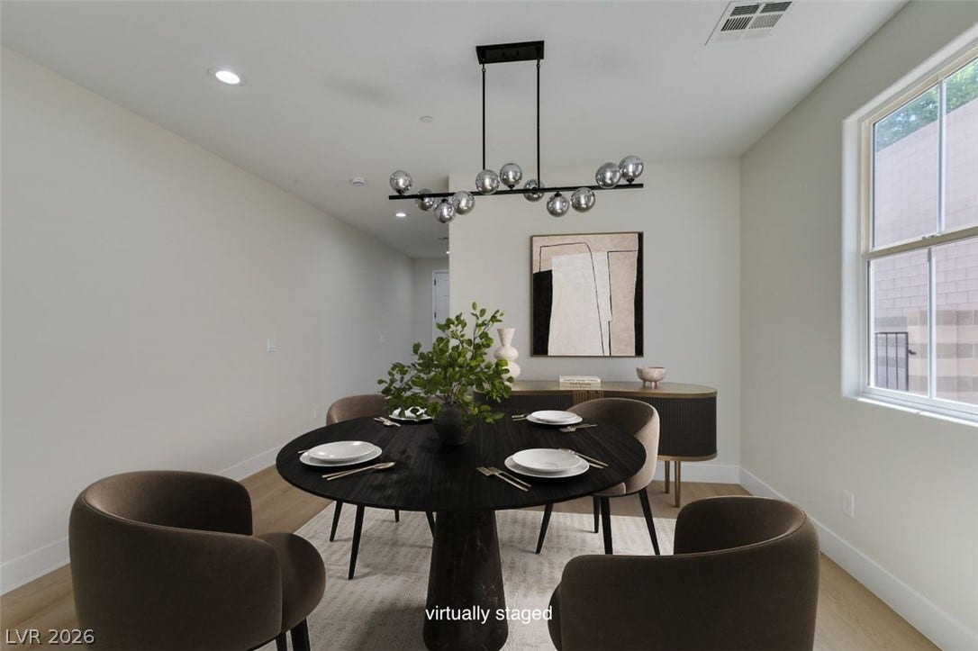 197 Sicily Hills Court, Henderson, NV 89012 A minimalist dining space boasts sleek wood flooring and a modern window drawing natural light.