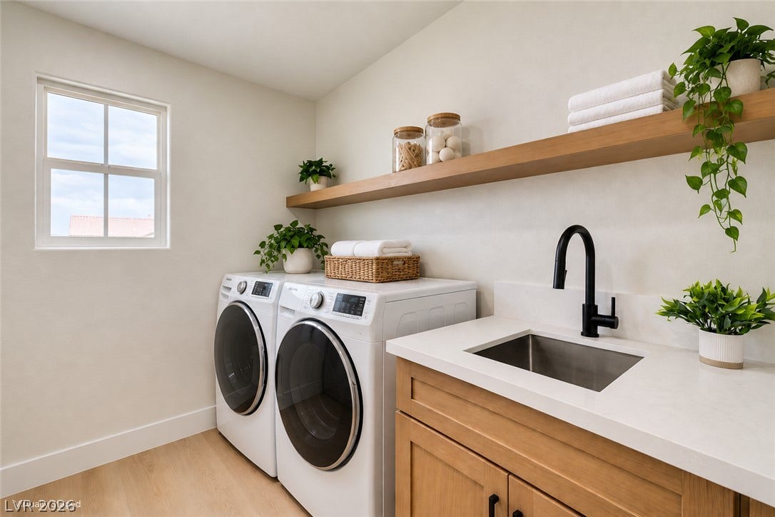 197 Sicily Hills Court, Henderson, NV 89012 A functional laundry space highlights warm wood cabinetry under a solid surface countertop.