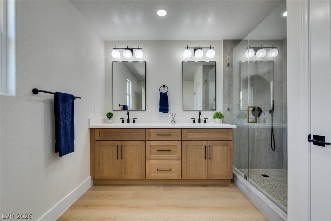 197 Sicily Hills Court, Henderson, NV 89012 Clean lines and a spacious dual vanity define this modern bathroom retreat.