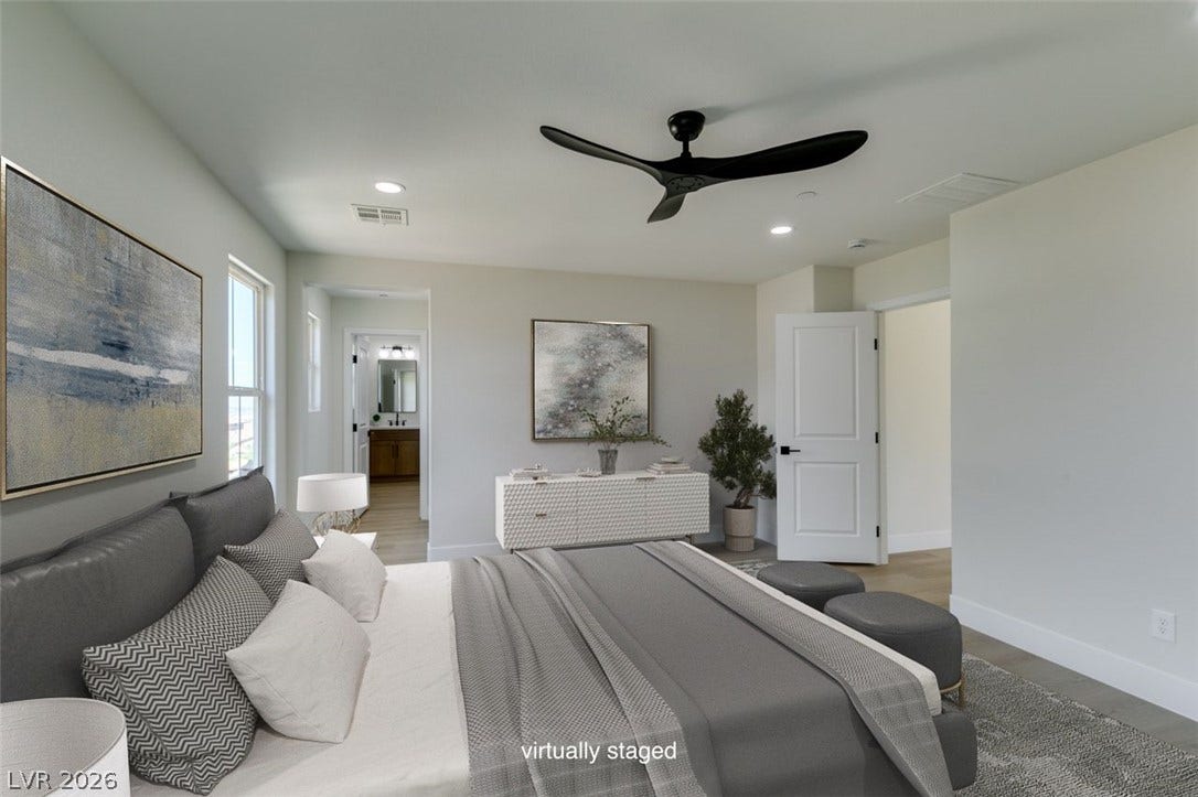 197 Sicily Hills Court, Henderson, NV 89012 Recessed lighting and warm wood flooring enhance the serene atmosphere of this modern bedroom suite.