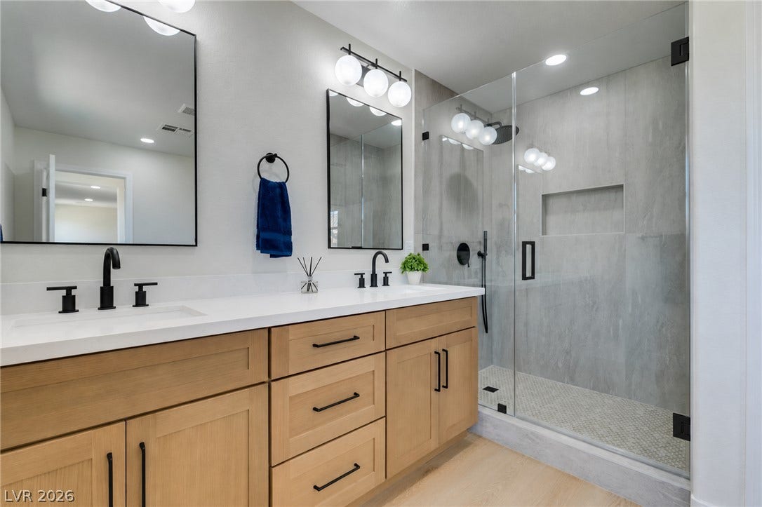 197 Sicily Hills Court, Henderson, NV 89012 Clean lines and a spacious glass shower define this contemporary double vanity bathroom.