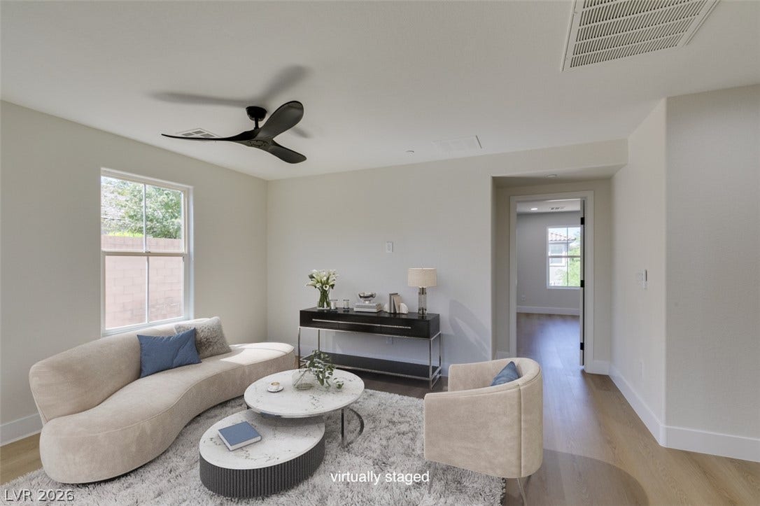 197 Sicily Hills Court, Henderson, NV 89012 Rich wood flooring runs throughout this airy living space with high ceilings and crisp finishes.