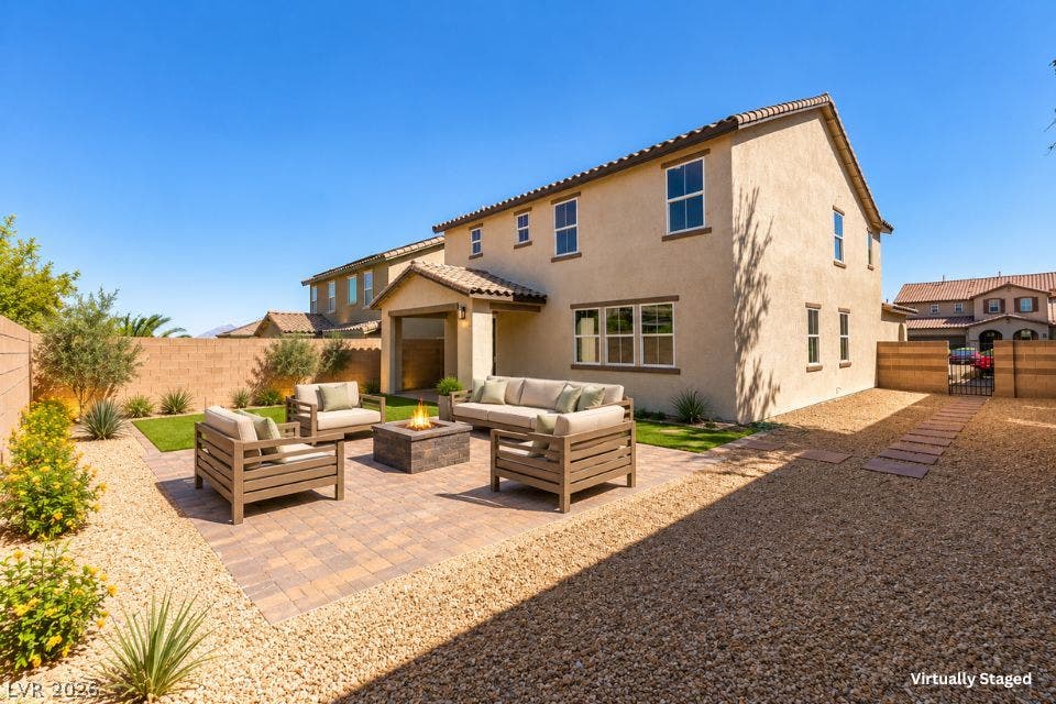 197 Sicily Hills Court, Henderson, NV 89012 A spacious stone paver patio offers an inviting outdoor gathering space beneath clear desert skies.