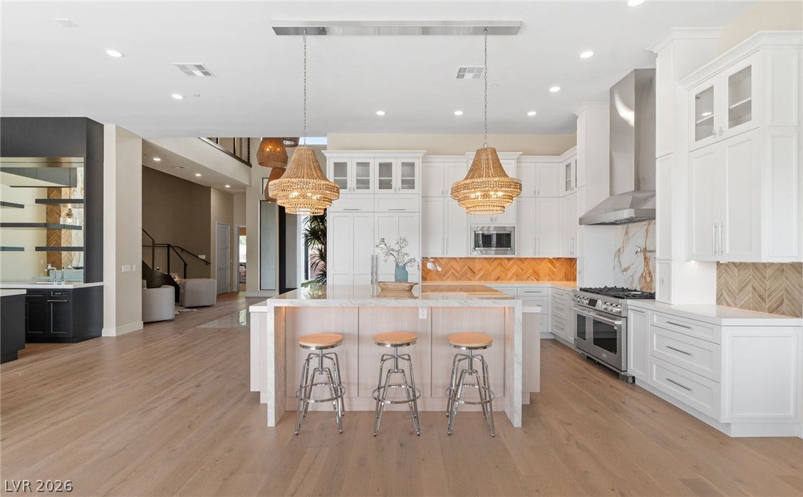 Gleaming hardwood floors and a spacious island anchor this light-filled modern kitchen.