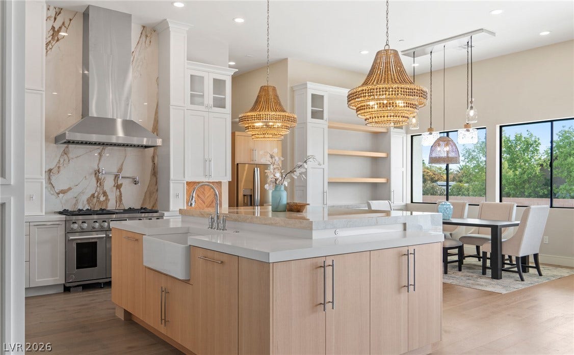High ceilings and a stone backsplash elevate this light-filled culinary space.