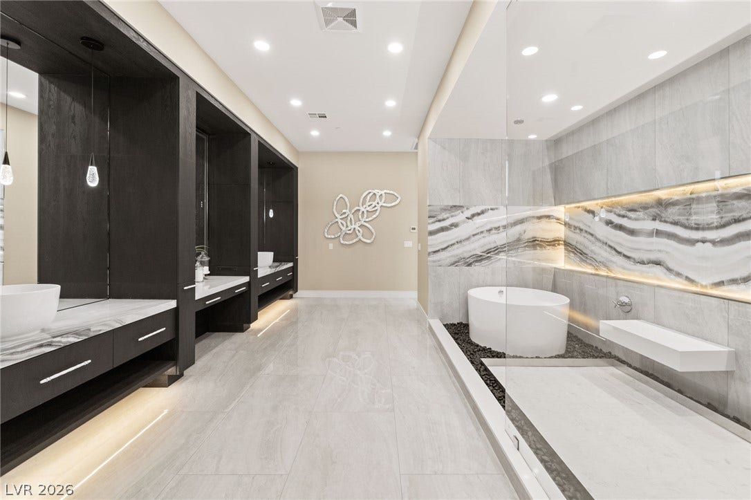 Gleaming tile floors and a modern wet-room shower define this spa-like retreat.