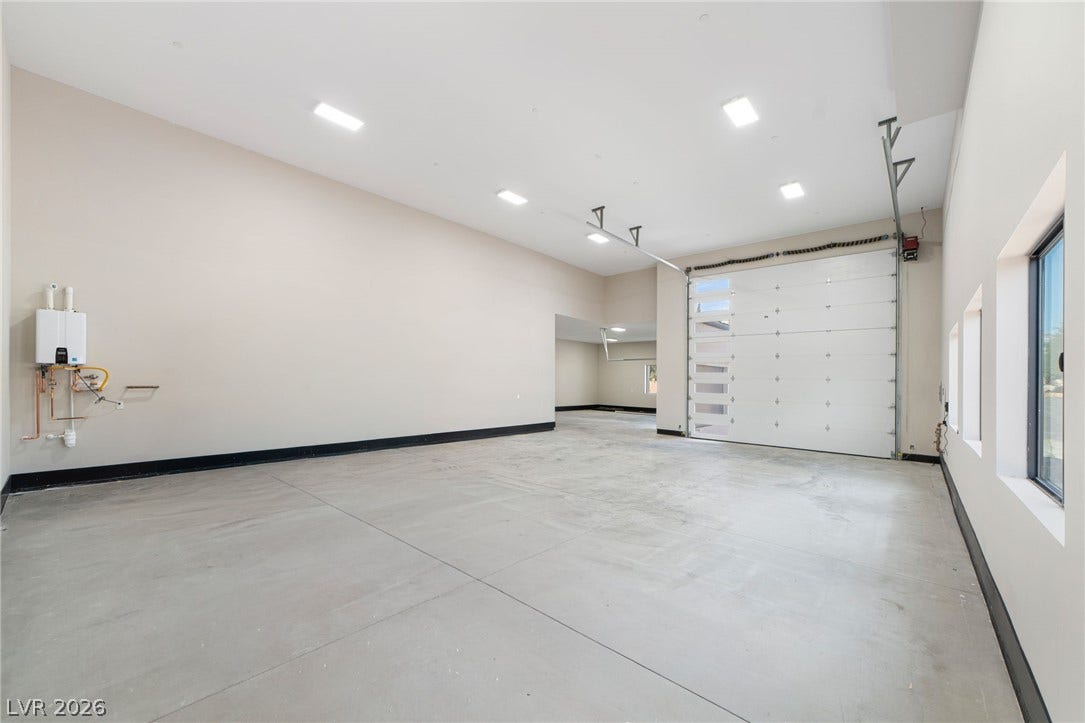 High ceilings and clean concrete floors define this incredibly spacious multi-car garage.