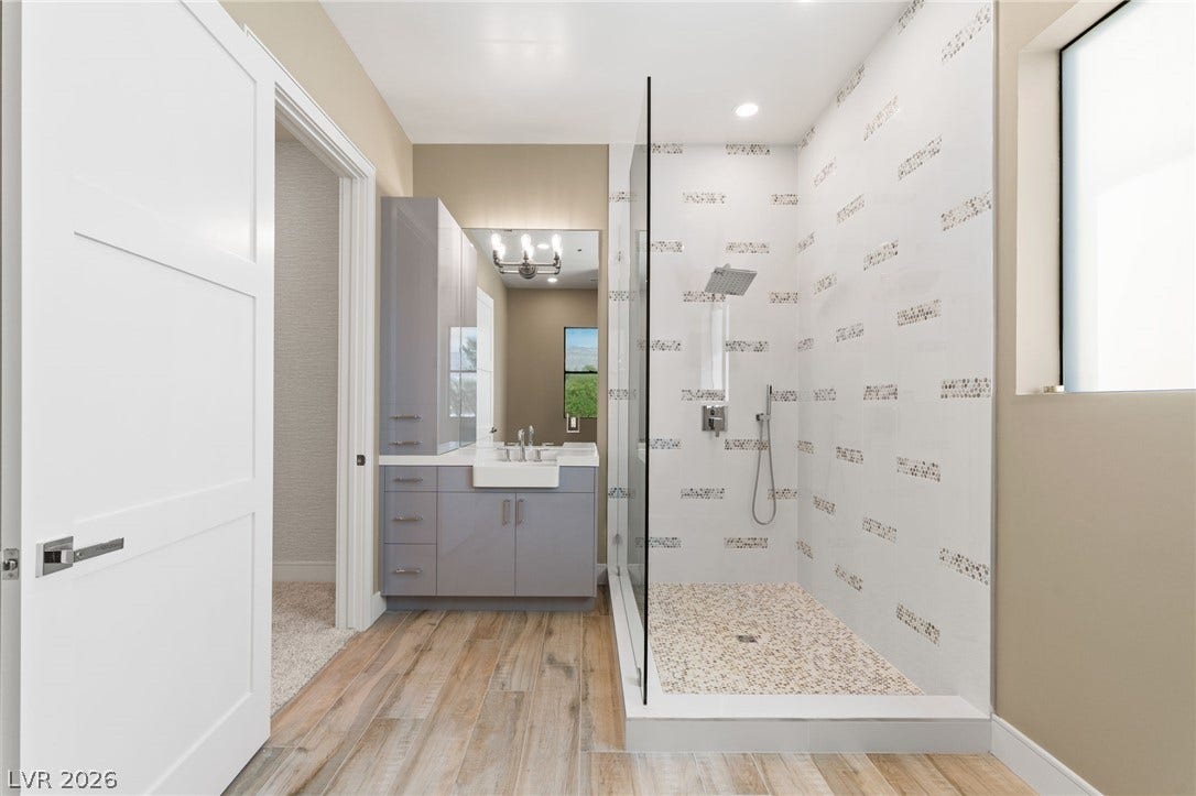 Sleek modern cabinetry and an expansive walk-in shower highlight this contemporary bathroom space.