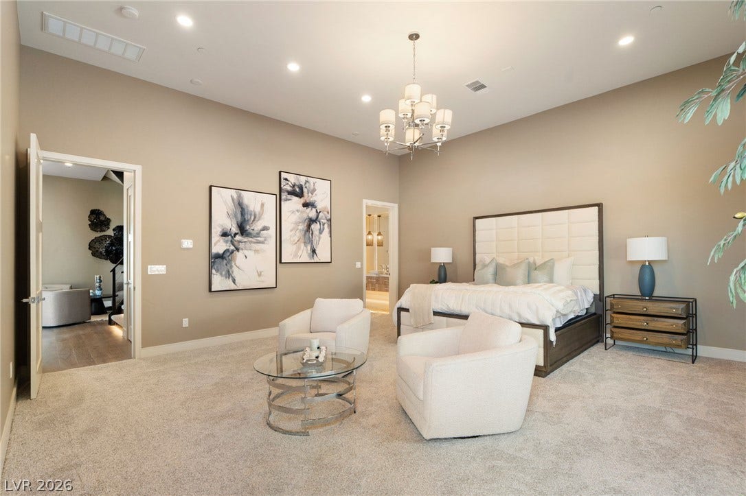 High ceilings and soft carpeting define this spacious main bedroom suite.