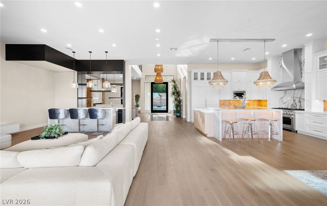 Gleaming hardwood floors and recessed lighting enhance this airy, open-concept living space.