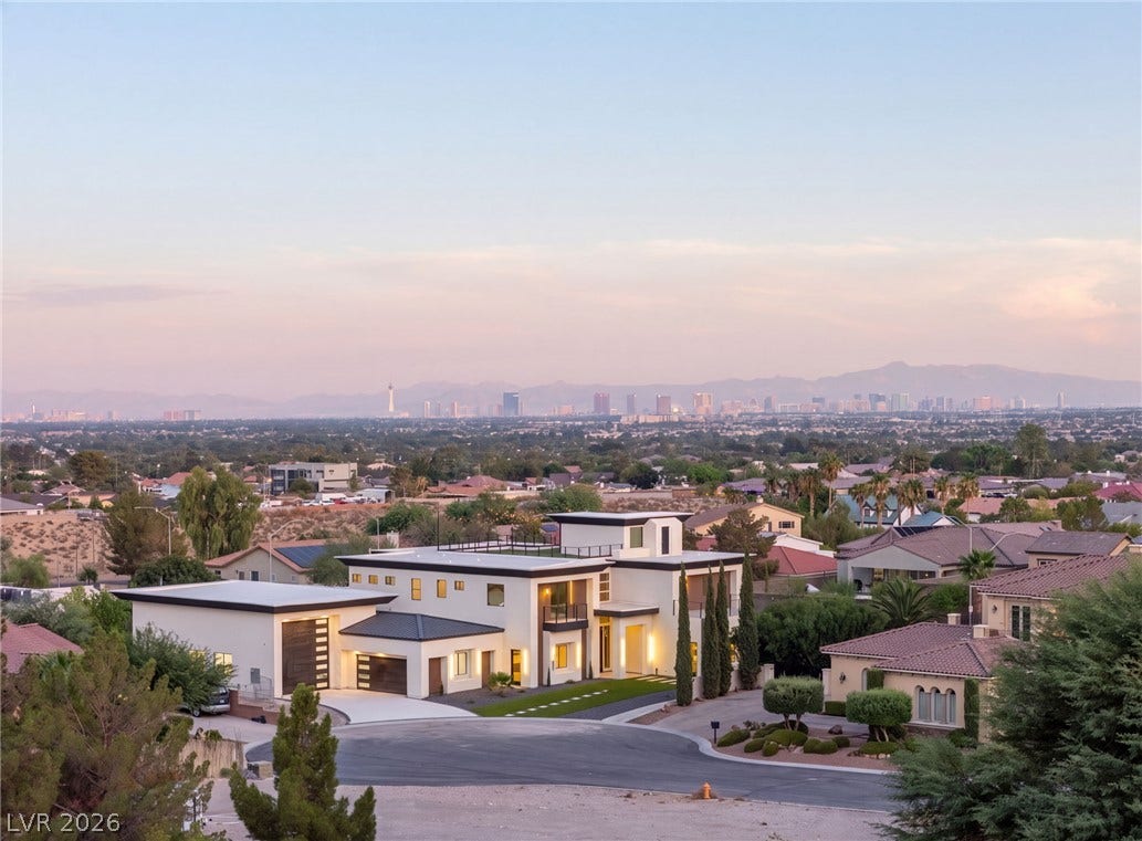 Distant city skyline views frame this modern estate nestled in a quiet cul-de-sac.