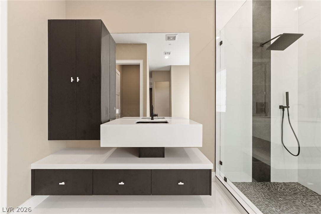 Clean lines and a modern floating vanity define this sleek master bathroom.