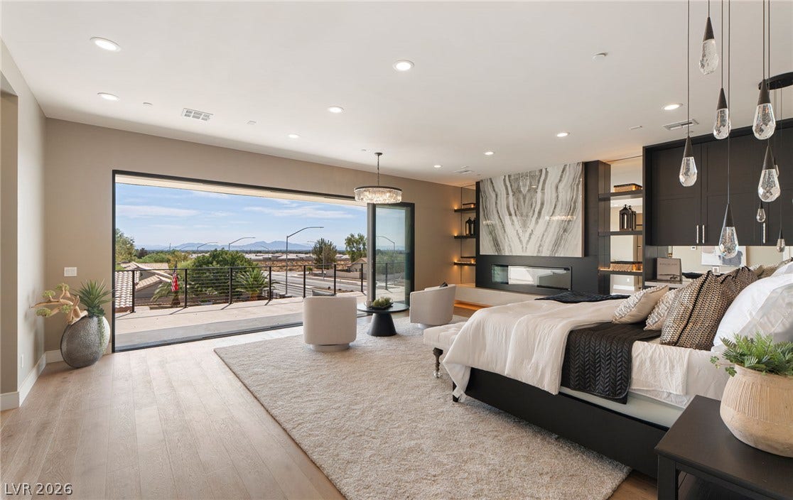 Wide sliding glass doors connect this primary suite to a scenic private balcony.