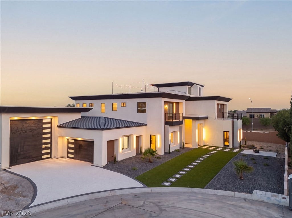 Striking contemporary architecture defines this luxury multi-level residence with a spacious paved driveway.