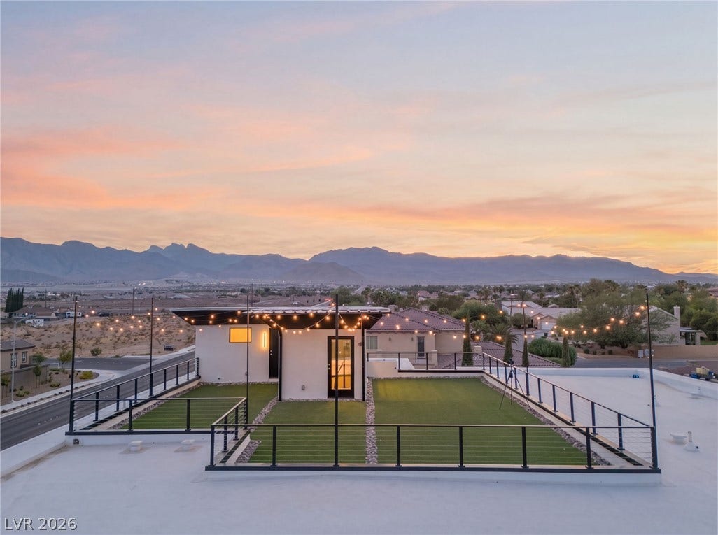 Panoramic mountain backdrops frame a spacious rooftop terrace perfect for evening relaxation.