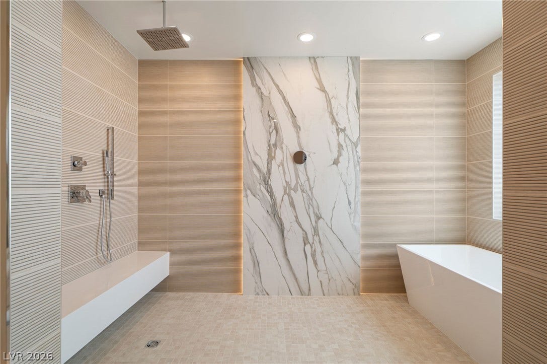 Fine tilework and a sleek soaking tub define this modern, spa-like wet room.