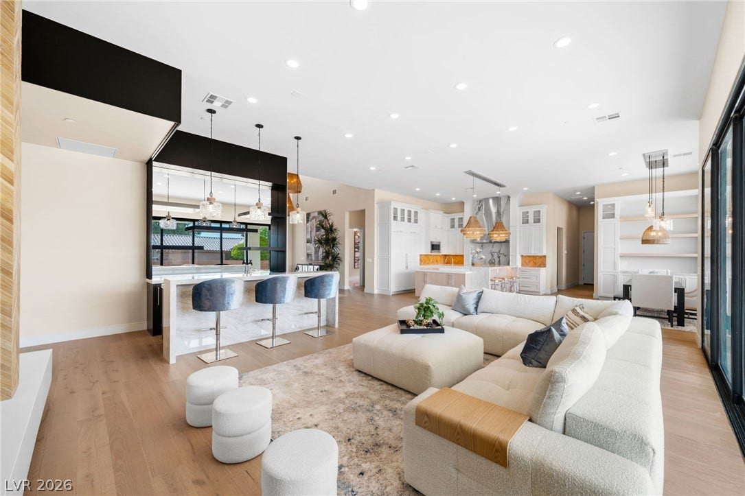 Gleaming wood floors and a soaring ceiling define this open-concept main level.