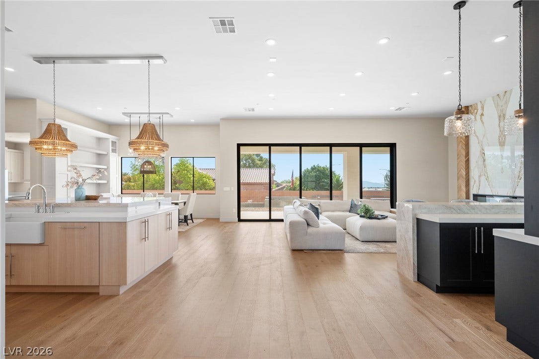Gleaming wood floors anchor an airy, open layout flowing seamlessly to the outdoors.