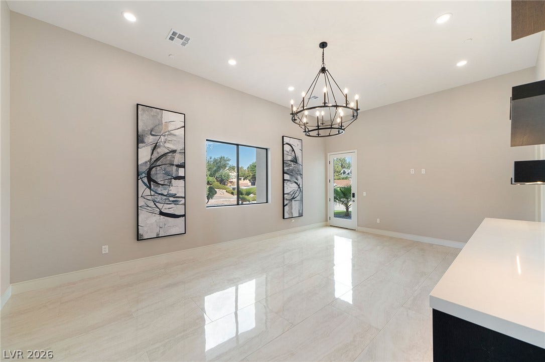 Polished tile flooring and high ceilings elevate this open dining area.