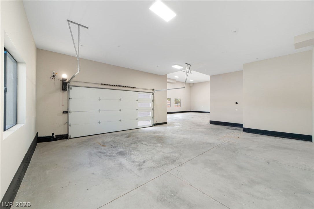 Smooth concrete flooring and high ceilings define this highly functional garage space.