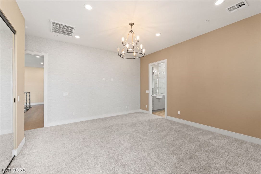 Plush carpeting anchors this expansive bedroom suite complete with an attached private bath.